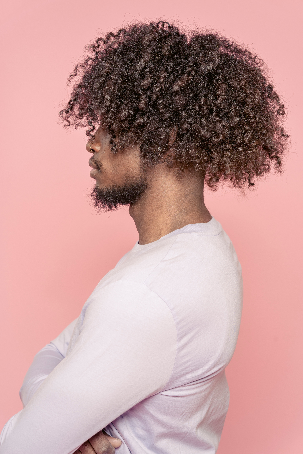 Serious black man with curly hair in studio
